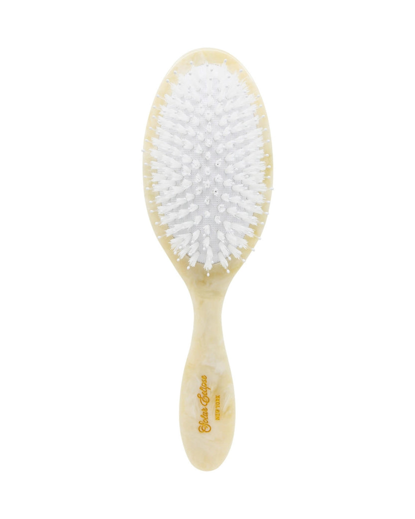 Front view of a hand-painted hair brush with white bristles and a brown-and-cream handle.
