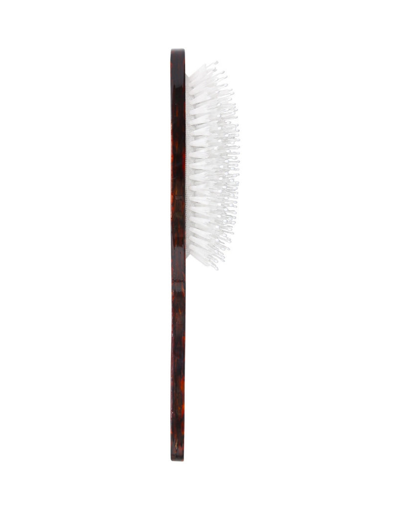 Side view of the brown patterned sunflower stem brush, showing the white bristles projecting from the handle.