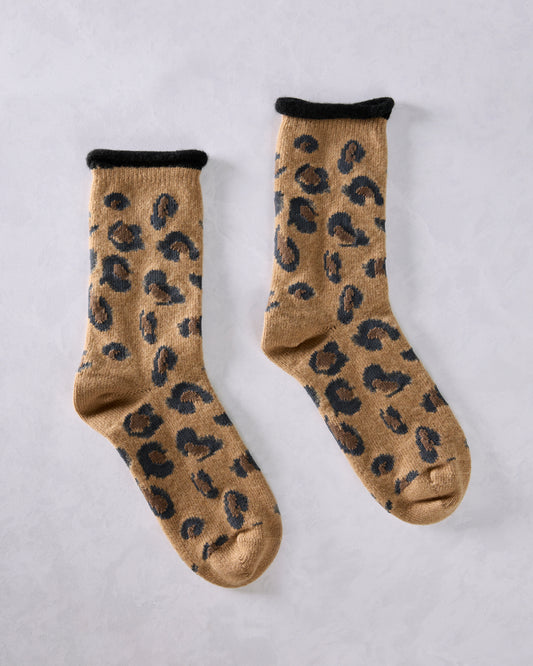 Pair of camel crew socks with black cuffs and an all-over black-and-brown spot pattern, shown side by side.