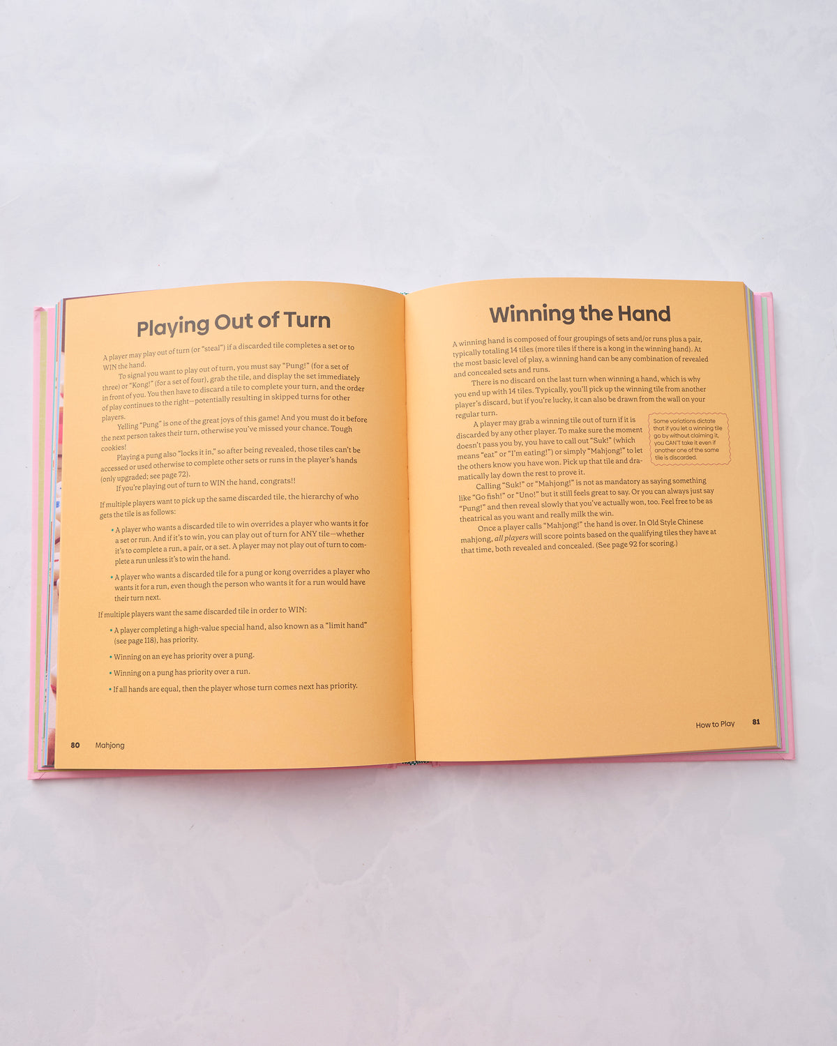 Open Mahjong book showing the interior spread titled “Playing Out of Turn” and “Winning the Hand.”