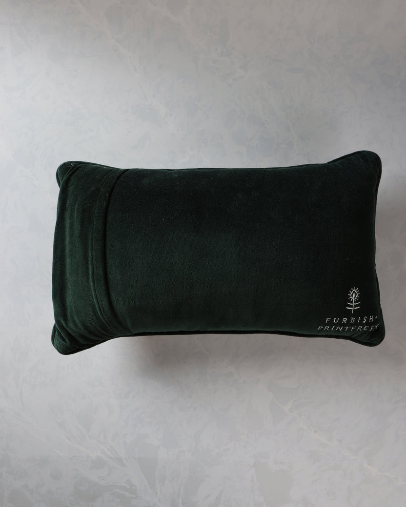 Reverse view of a dark green rectangular throw pillow with the Furbish Printfresh logo embroidered near the lower right corner.
