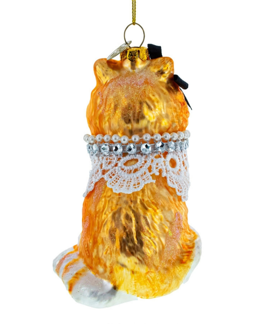 Gold glass cat Christmas ornament with a hanging cord, lace collar, and beaded trim
