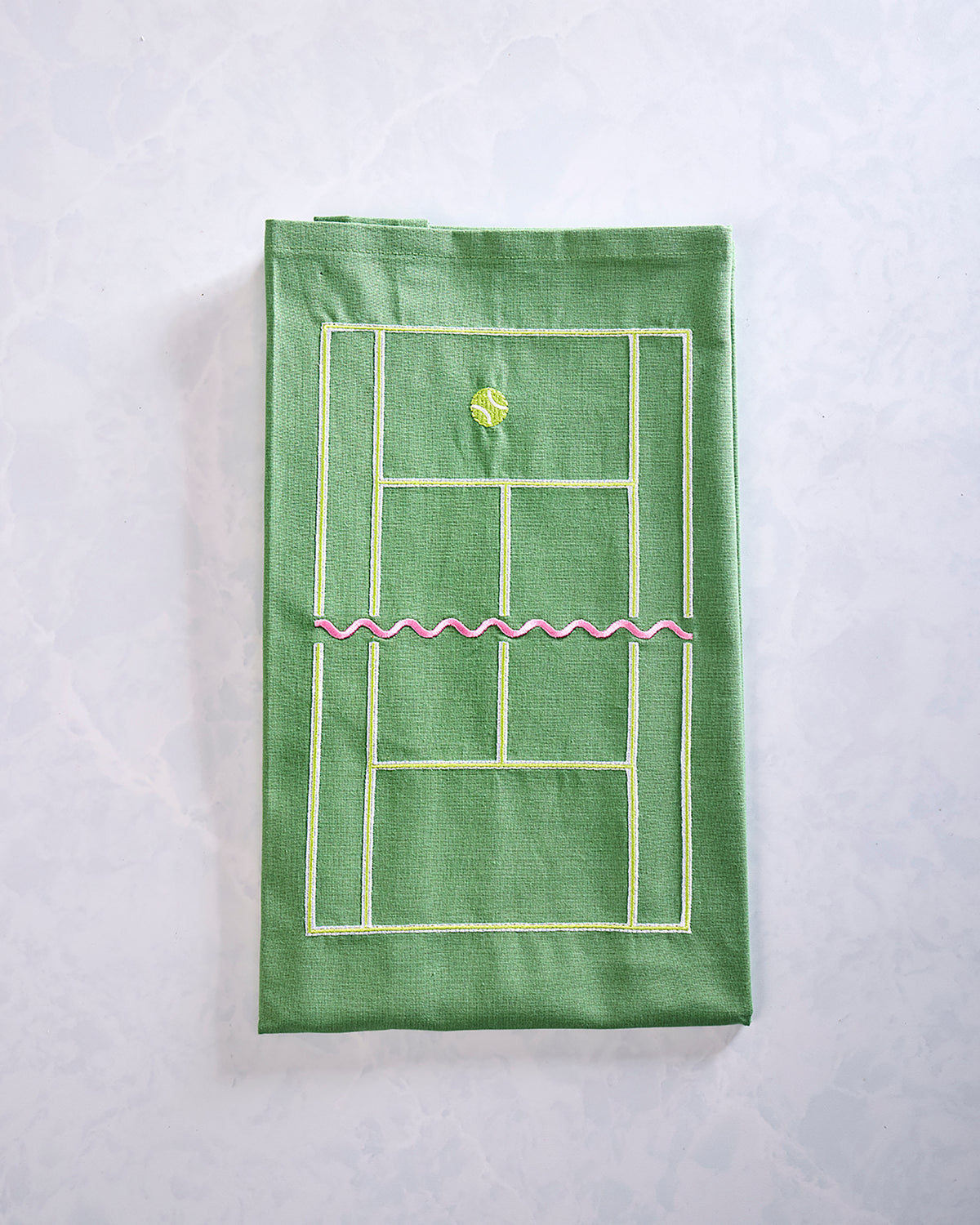 Green tea towel featuring an embroidered tennis court diagram, tennis ball, and pink center line.