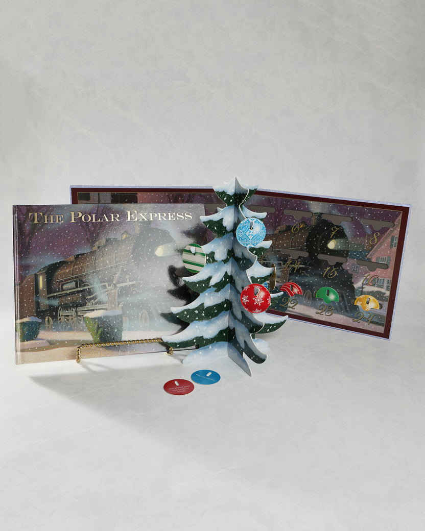 Opened Polar Express Christmas countdown set displaying a freestanding Christmas tree with ornaments, a train-themed calendar, and two activity cards.