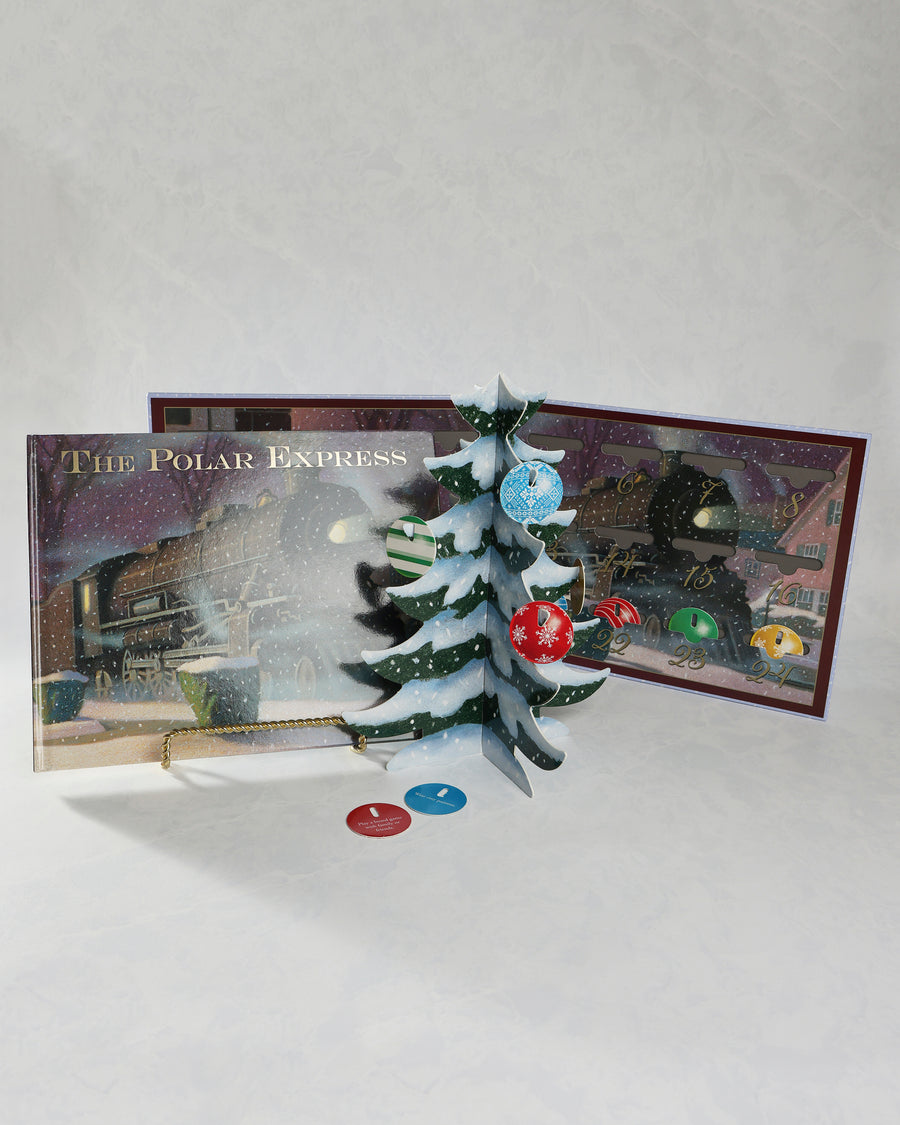 Opened Polar Express Christmas countdown set displaying a freestanding Christmas tree with ornaments, a train-themed calendar, and two activity cards.
