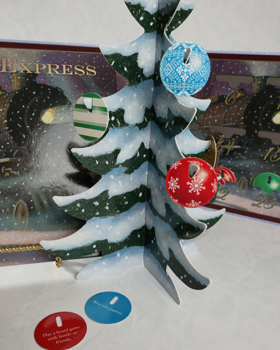 Close-up of the Polar Express countdown tree with blue, green, red, and patterned ornaments, plus two activity cards below.