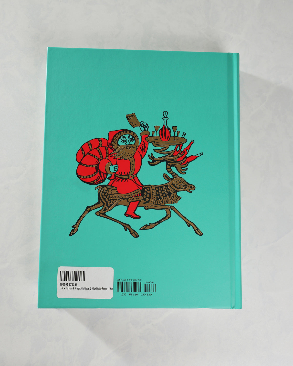 Back cover of Fortnum & Mason Christmas & Other Winter Feasts in teal, with an illustrated rider carrying food and drinks.