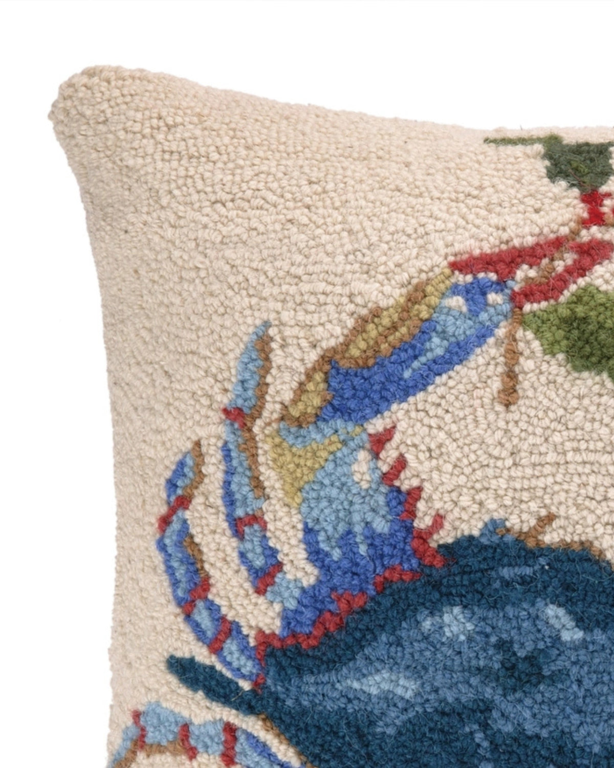 Close-up of the blue crab and textured hooked detail on the ivory pillow