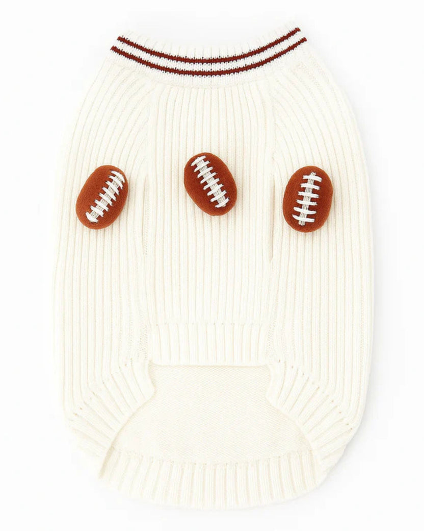 Back view of an ivory dog sweater with three brown football appliqués