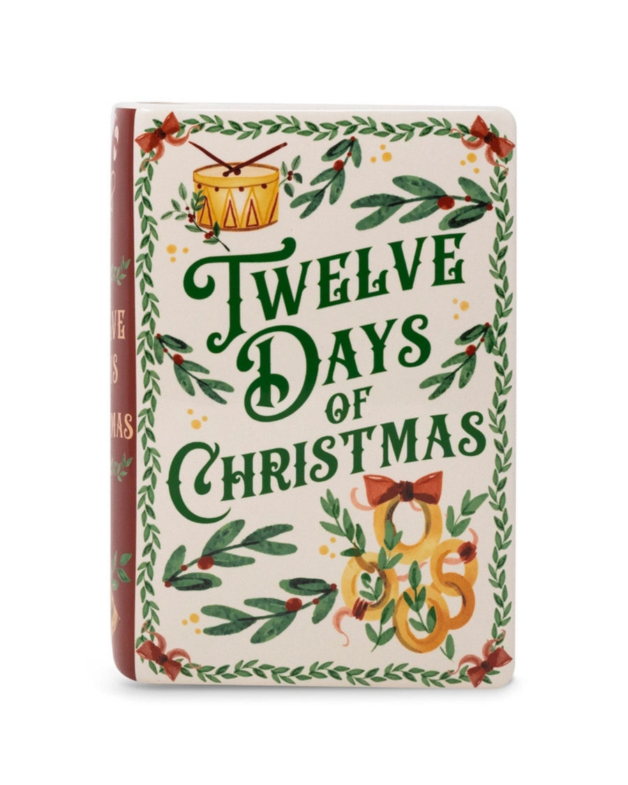 Front view of the book-style vase decorated with greenery, bows, birds, a drum, and the words “Twelve Days of Christmas.”