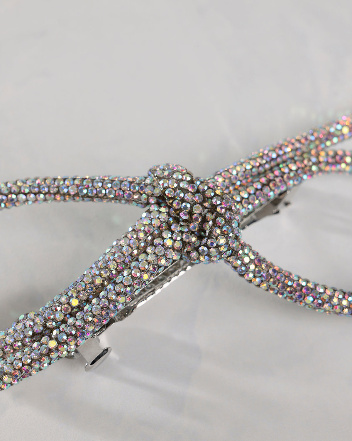 Close-up of the silver sparkling bow barrette’s jeweled center
