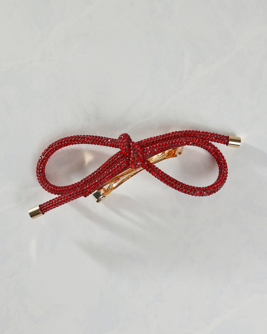 Red sparkling bow barrette shown from the front