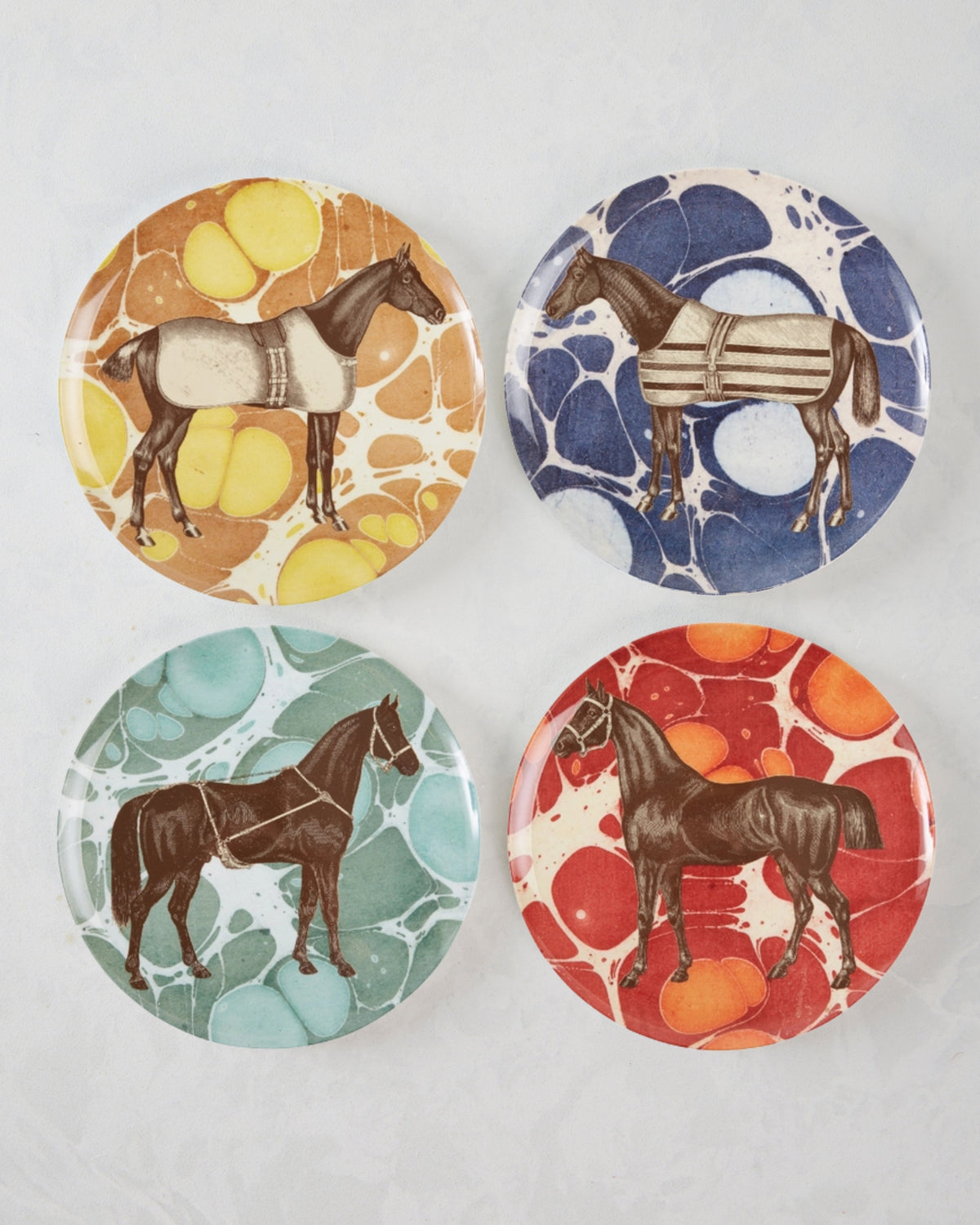 Set of four round melamine dinner plates, each featuring an illustrated horse on a different marbled background in orange, blue, green, or red.