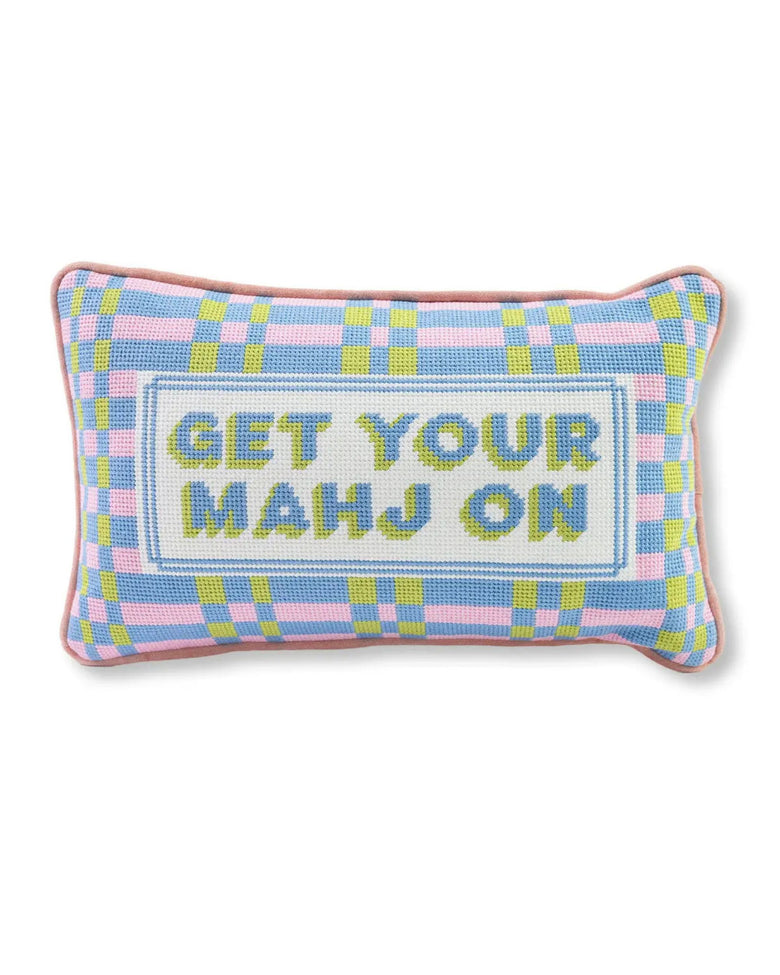 Needlepoint pillow with a blue, pink, and green plaid border and the wording “GET YOUR MAHJ ON.”