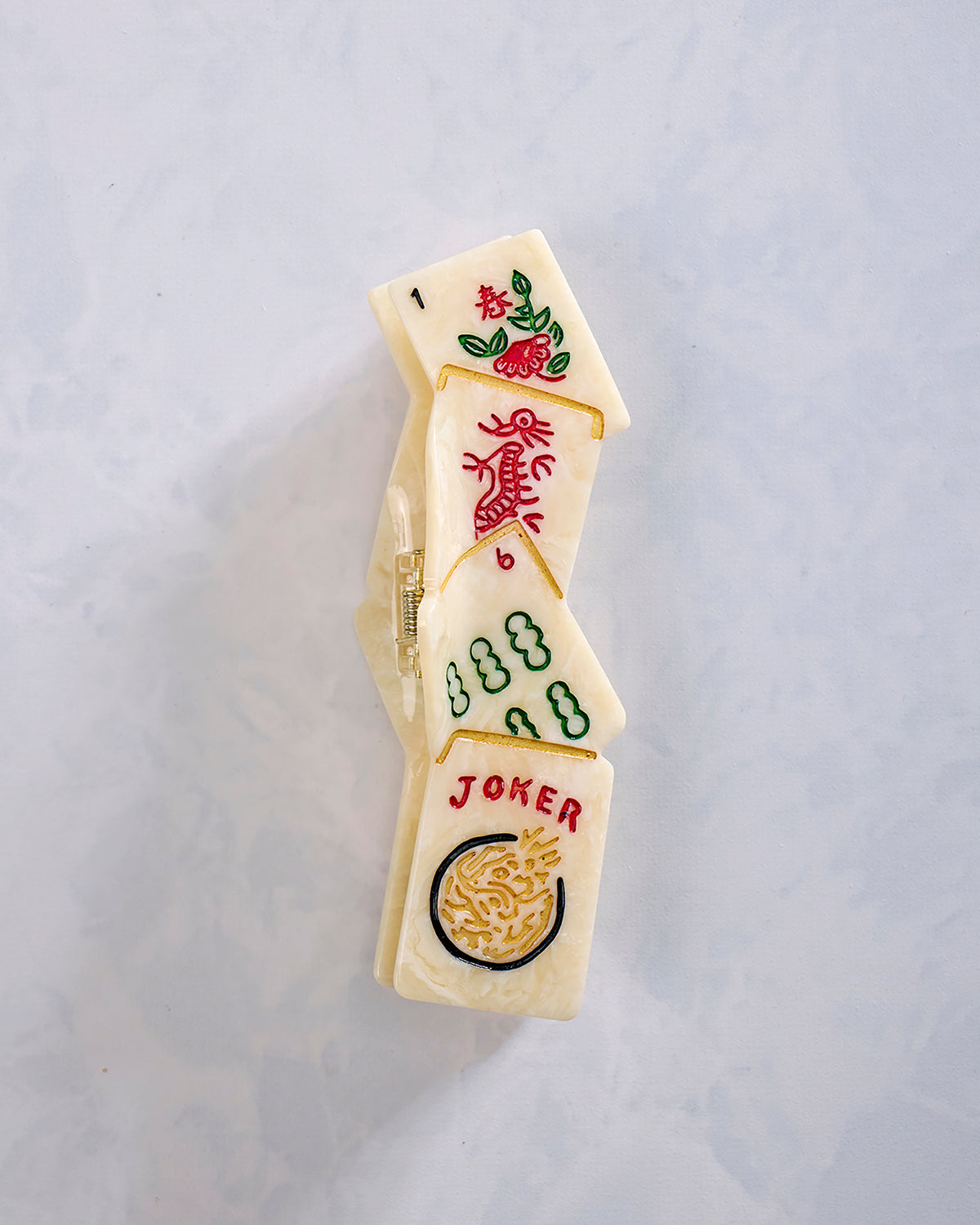Hand-painted mahjong tile claw clip shown vertically, with visible JOKER, number, and colorful tile symbols.