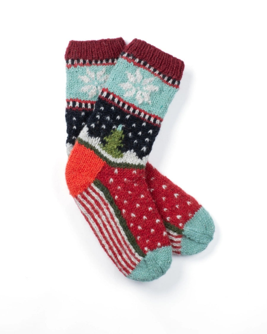 Pair of knitted holiday socks with red, turquoise, navy, white, and green patterns, including snowflakes and a Christmas tree.