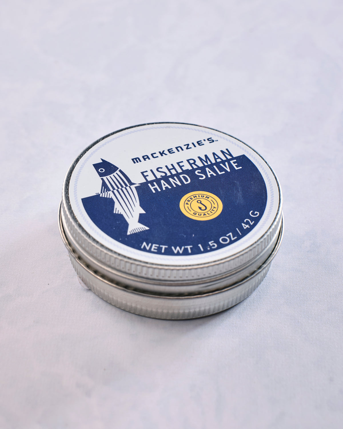 Round metal tin of MacKenzie's Fisherman Hand Salve shown from above.