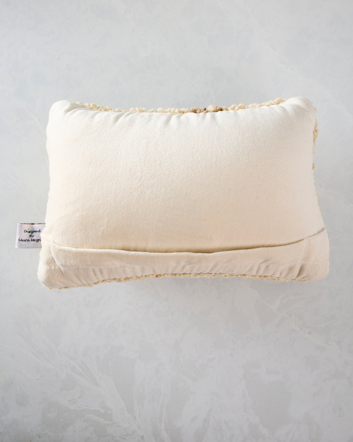 Back view of the ivory Perky Turkey pillow showing its plain back and lower seam.
