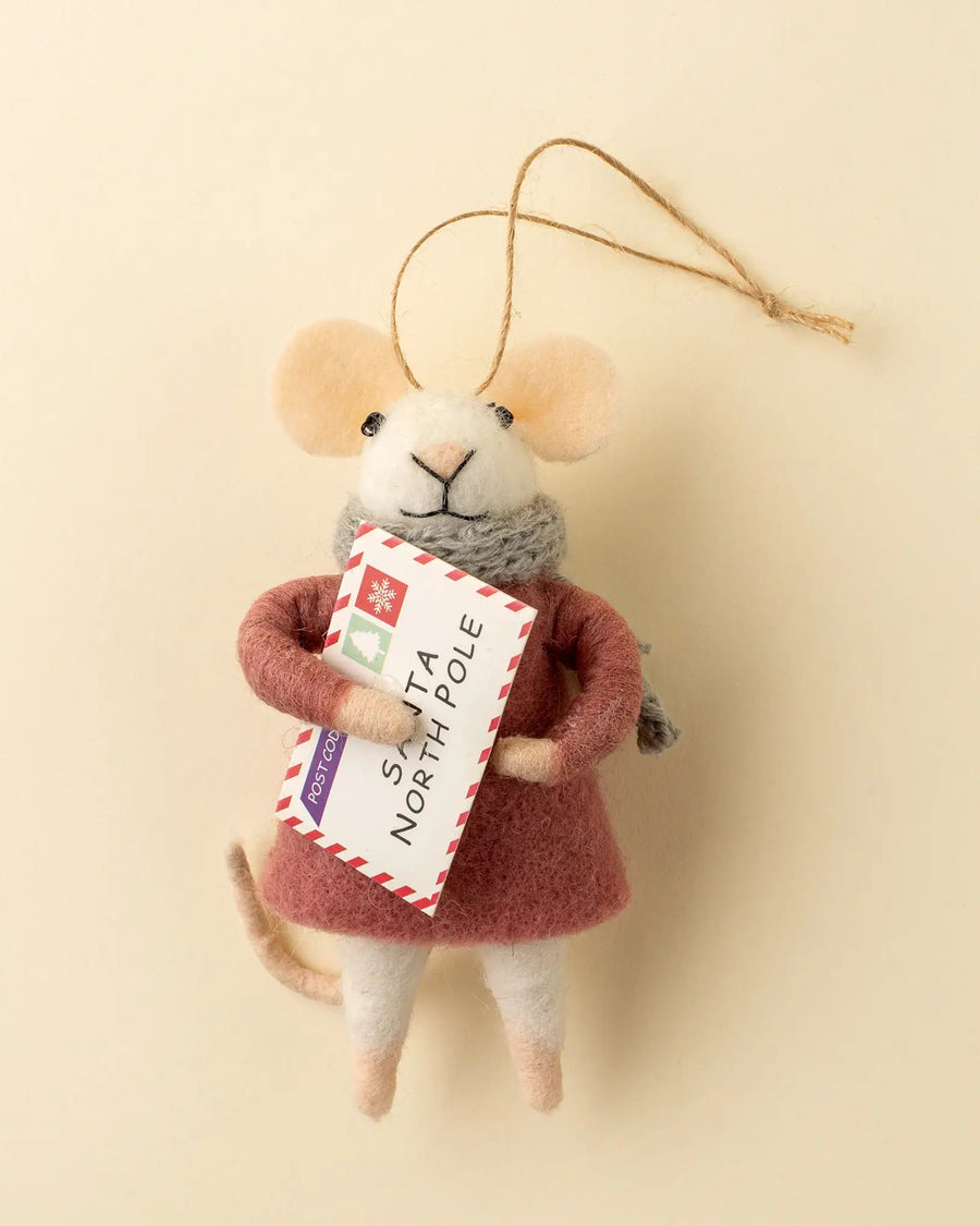 Felt mouse ornament wearing a rust-colored coat and gray scarf while holding an envelope labeled Santa North Pole.
