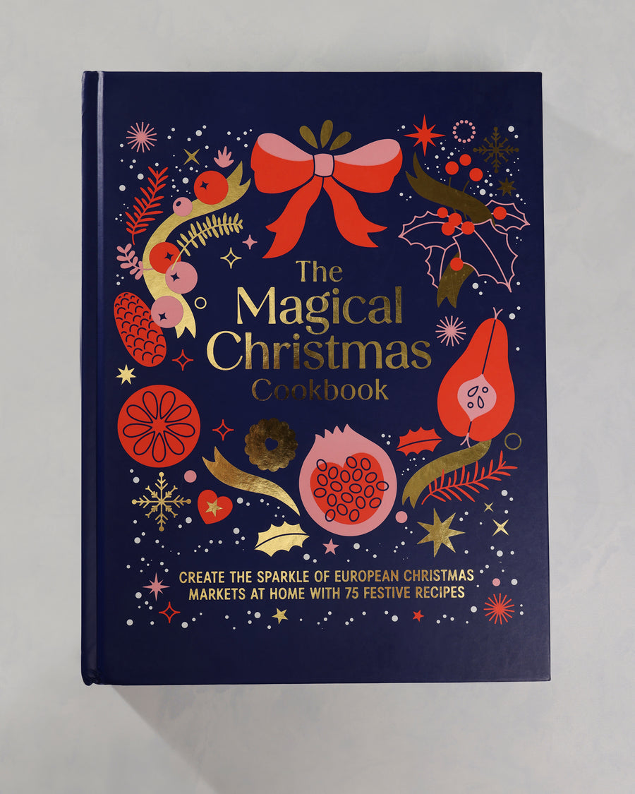 Front cover of The Magical Christmas Cookbook, featuring colorful Christmas illustrations on a dark navy background.