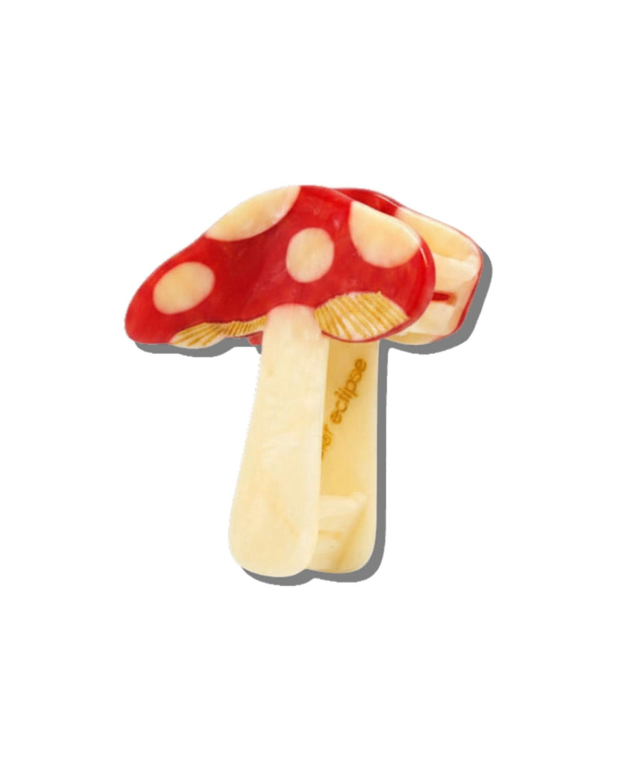 Red mushroom claw hair clip shown partly open, revealing the second side and the internal hinge.