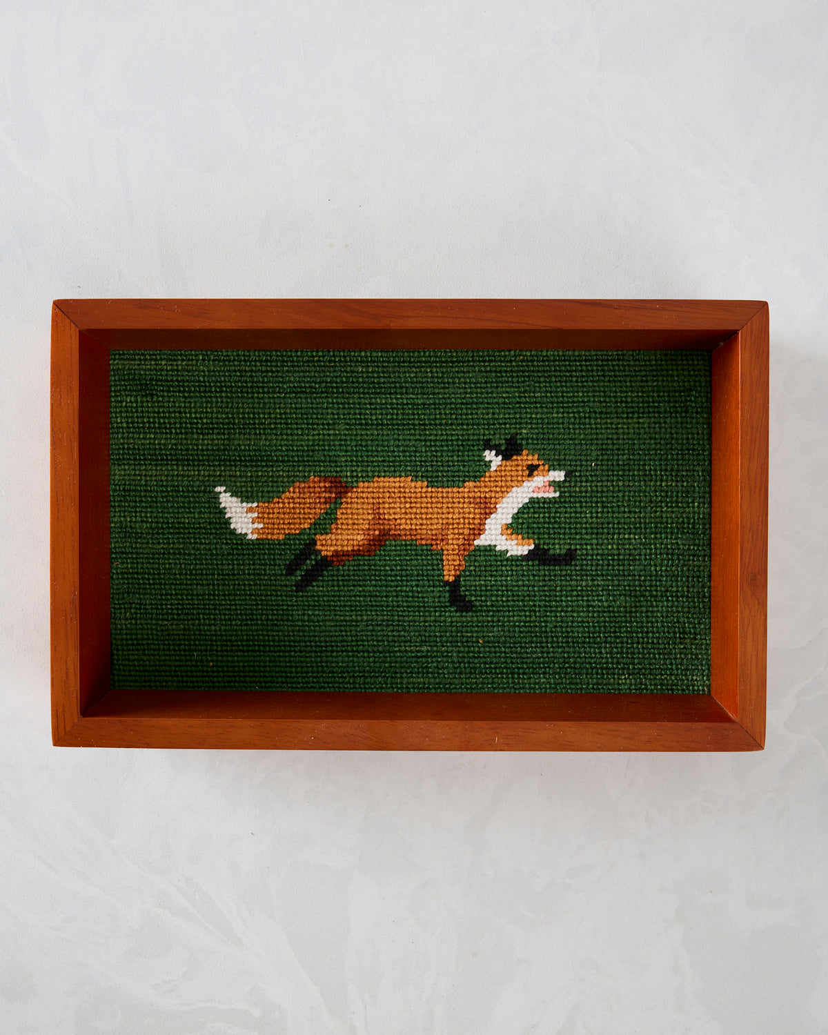Top view of the dark green fox needlepoint valet tray in a brown wooden frame.