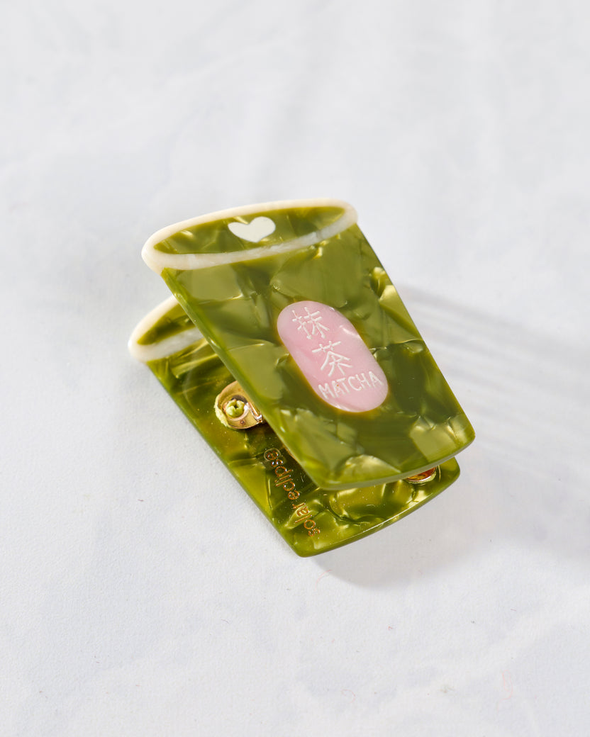 Green hand-painted mini matcha claw hair clip with translucent swirled detailing and a pink MATCHA label