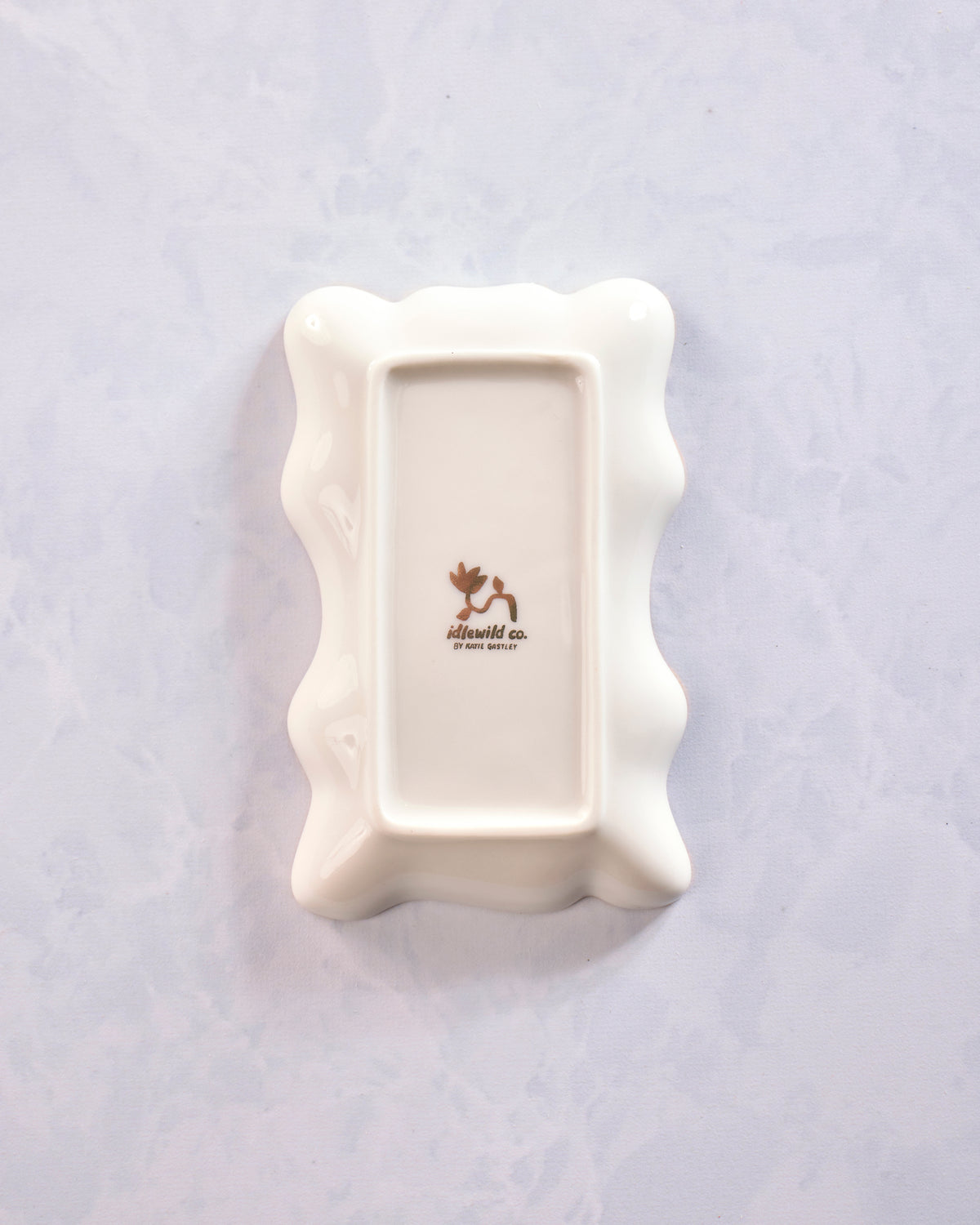 Back of a white porcelain trinket dish showing the Idlewild Co. mark.