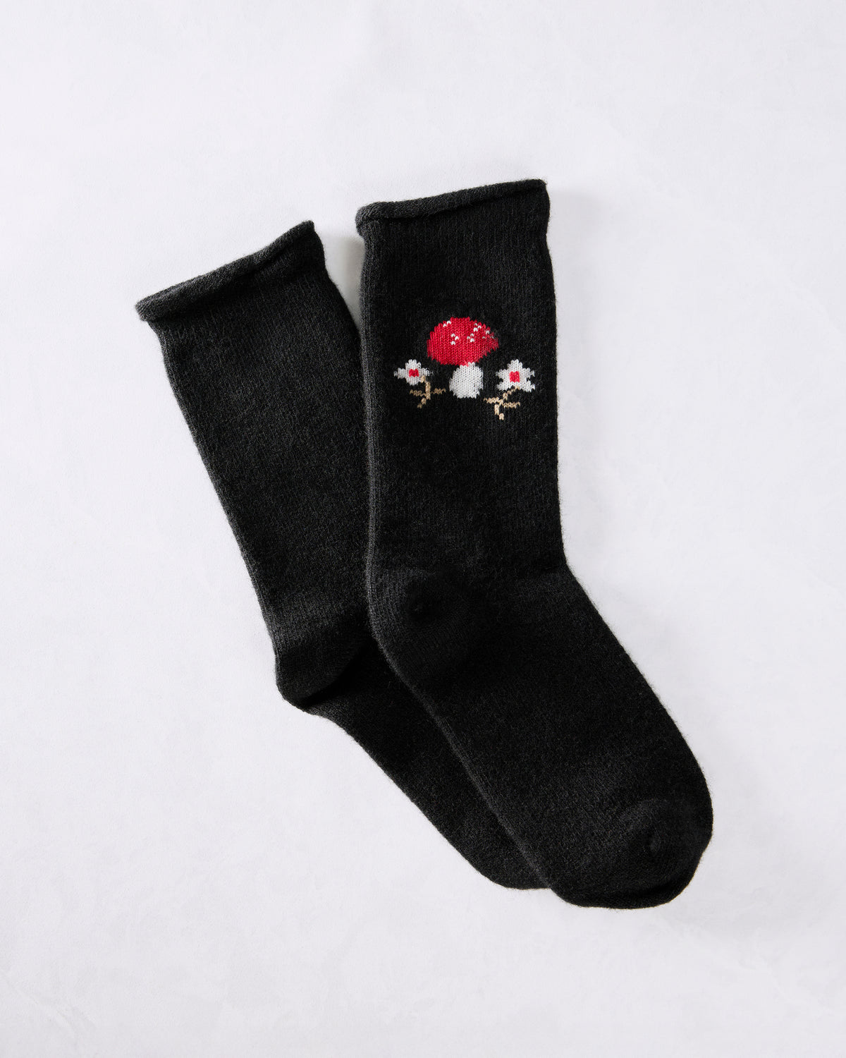 Pair of black crew socks with a red-and-white toadstool motif near the cuffs.