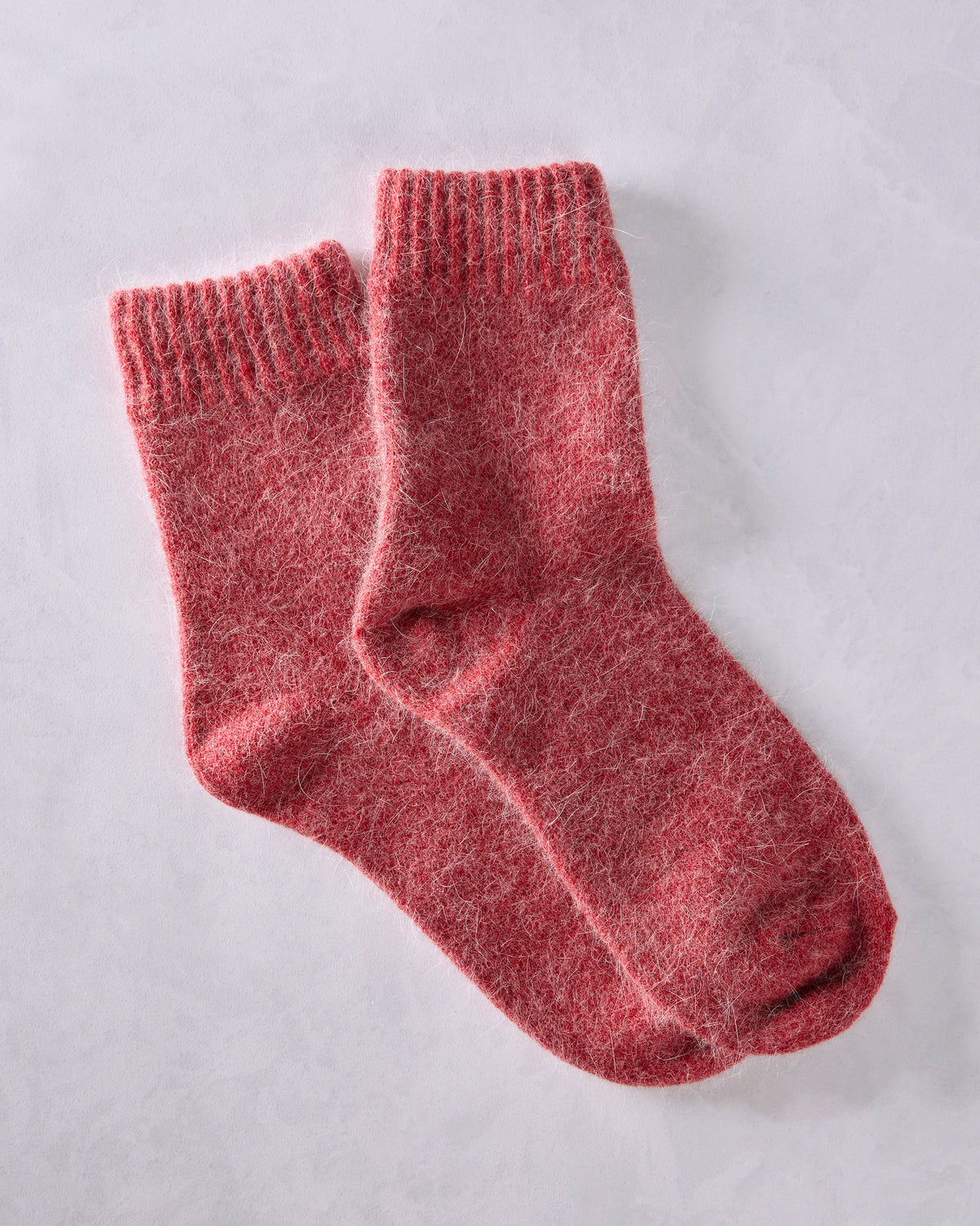 Pair of red crew socks overlapping at an angle.