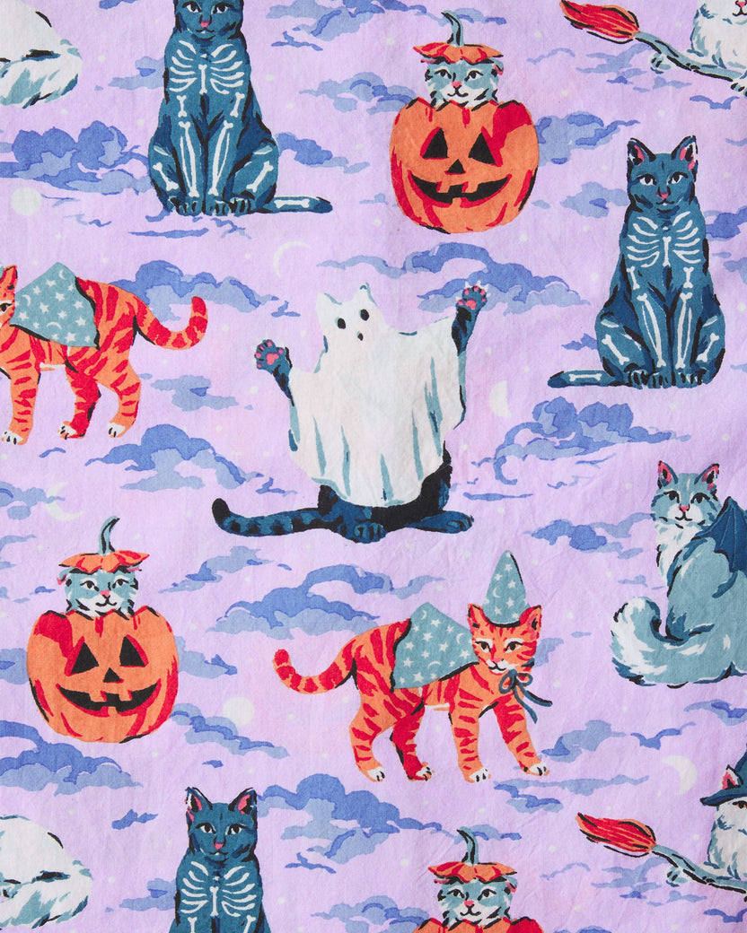 Lavender Halloween House Cats pajama print with black cats, pumpkin-headed cats, orange tabby cats in witch hats, and a white ghost among purple clouds.