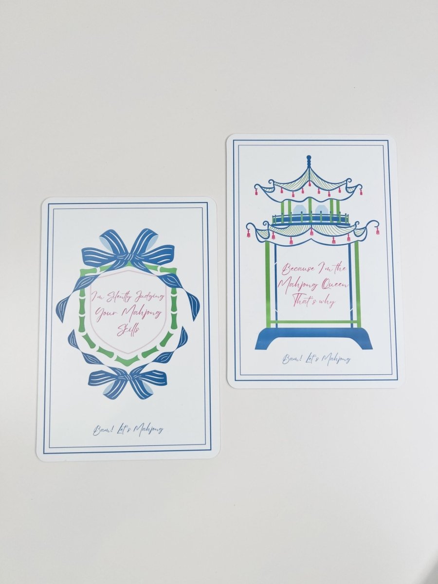 Two Mahjong tile shufflers shown together, with a blue-and-green bow design and a carousel design featuring printed phrases.