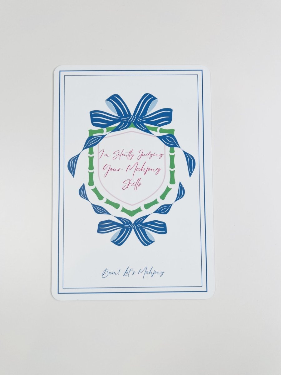 Blue and green Mahjong tile shuffler with a bow-and-wreath design and the phrase “I'm Silently Judging Your Mahjong Skills.”