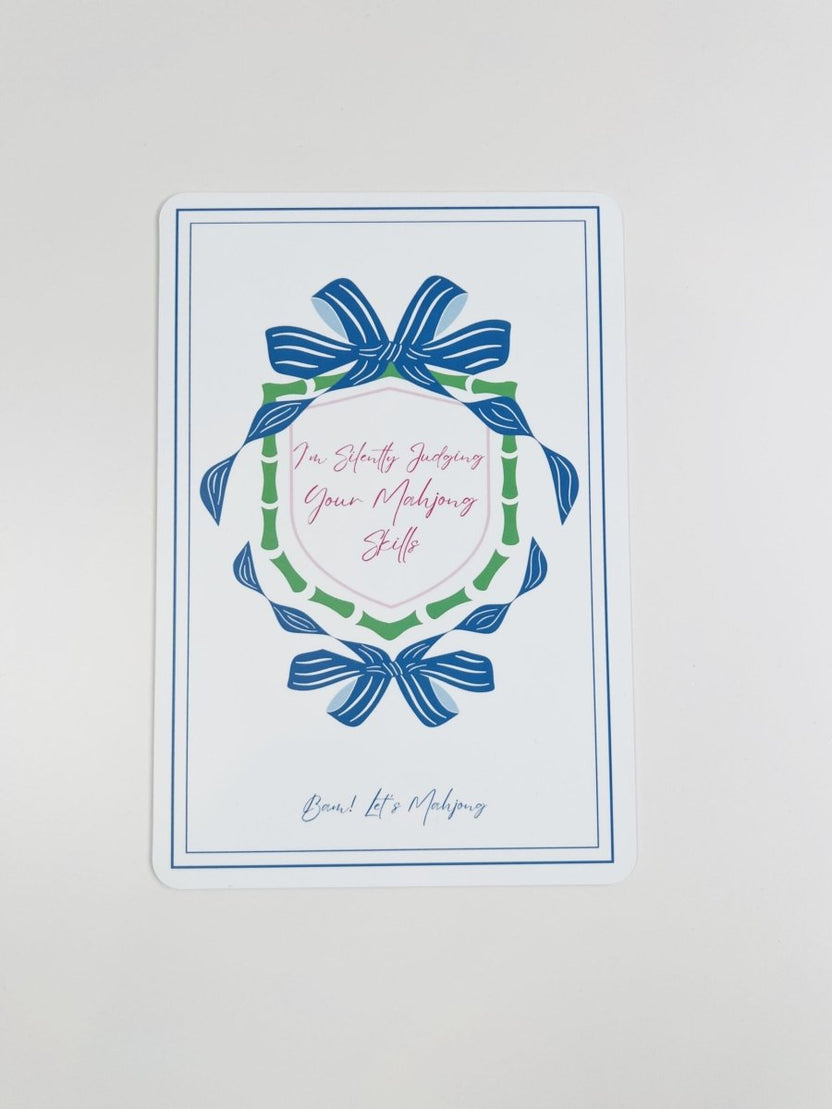 Blue and green Mahjong tile shuffler with a bow-and-wreath design and the phrase “I'm Silently Judging Your Mahjong Skills.”